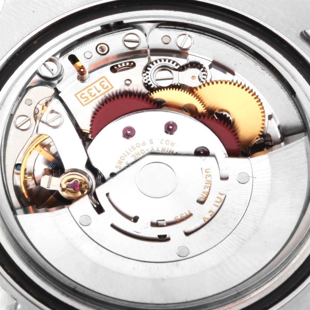 The image shows a close-up view of the internal mechanism and gears of a Rolex Submariner 116610LV Men
s Stainless Steel Green Dial 116610LV Men
s Stainless Steel Green Dial watch.