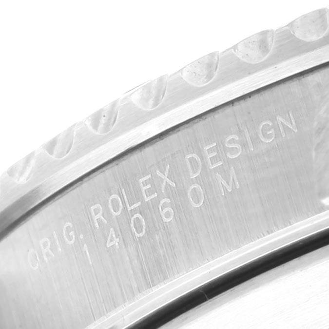 This image shows a close-up of the side engraving on a Rolex Submariner 14060 Men
s Stainless Steel Black Dial 14060 Men
s Stainless Steel Black Dial watch, including the model number 14060M.
