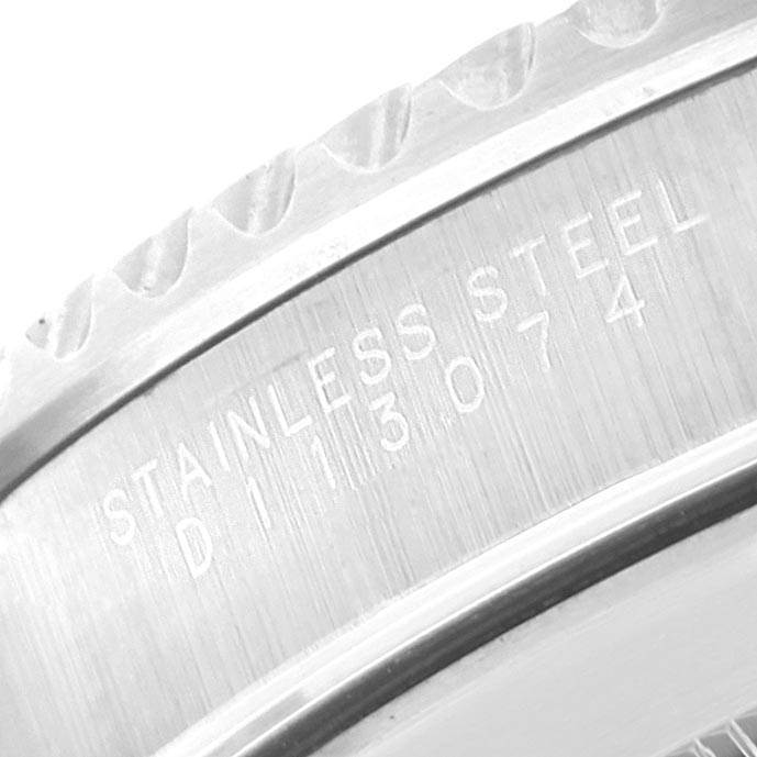 This close-up image shows the stainless steel inscription and serial number engraving on the bezel and case back of a Rolex Submariner 14060 Men
s Stainless Steel Black Dial 14060 Men
s Stainless Steel Black Dial watch.