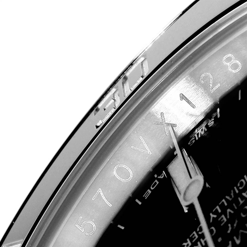 A close-up view of the Rolex Submariner 116610 Men
s Stainless Steel Black Dial 116610 Men
s Stainless Steel Black Dial shows a segment of the bezel, crystal, and part of the dial with hour markers.