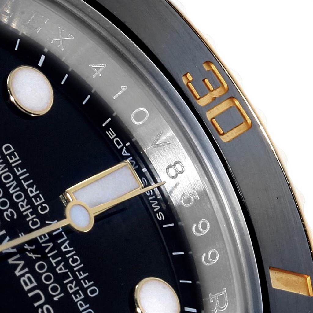 The image shows a close-up of the dial, bezel, and hour markers of a Rolex Submariner 116613 Men's Steel and Gold (two tone) Black Dial 116613 Men's Steel and Gold (two tone) Black Dial watch from an angled view.