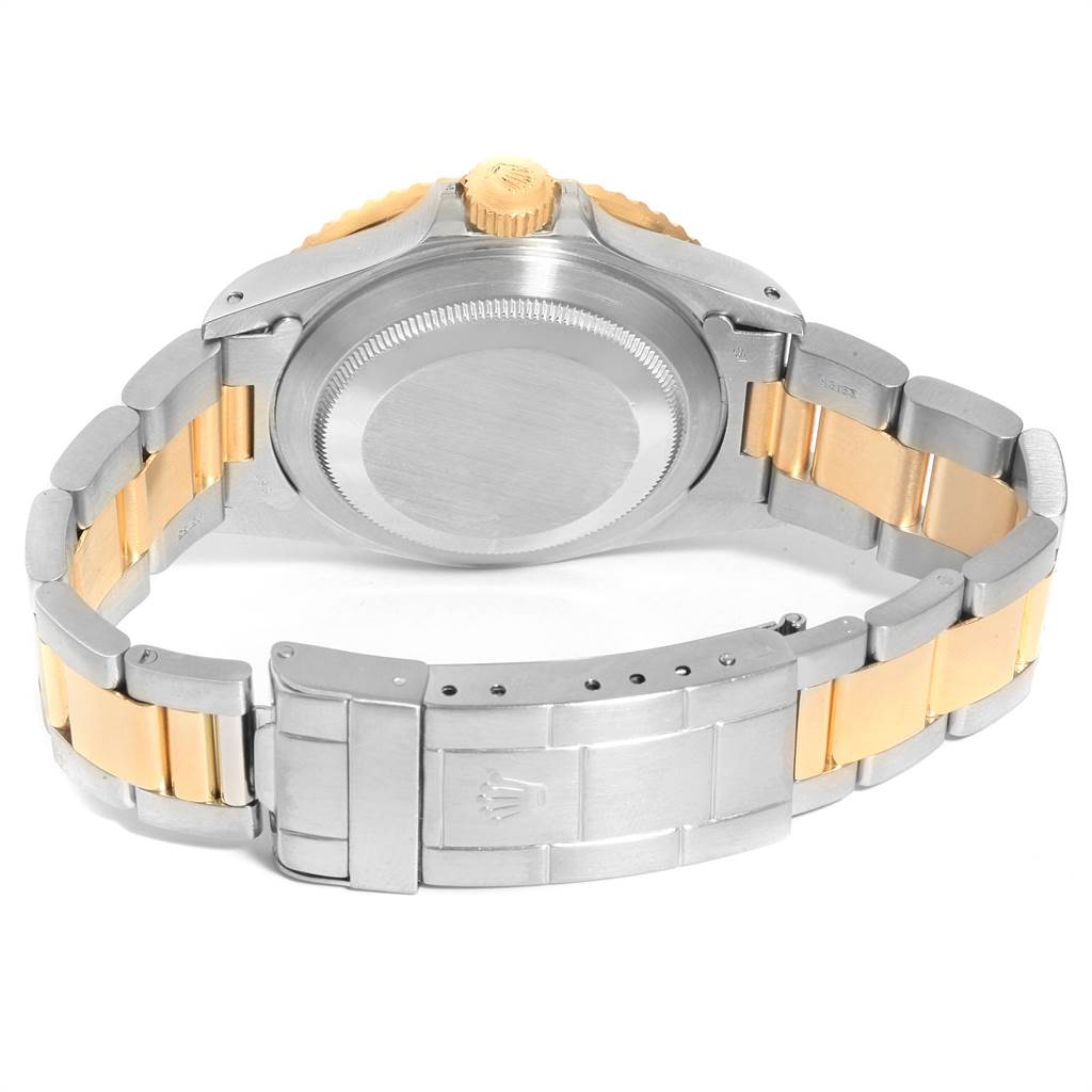 The image shows the back of a Rolex Submariner 16803 Men
s Steel and Gold (two tone) Blue Dial 16803 Men
s Steel and Gold (two tone) Blue Dial, highlighting the case back, crown, and two-tone bracelet with clasp.