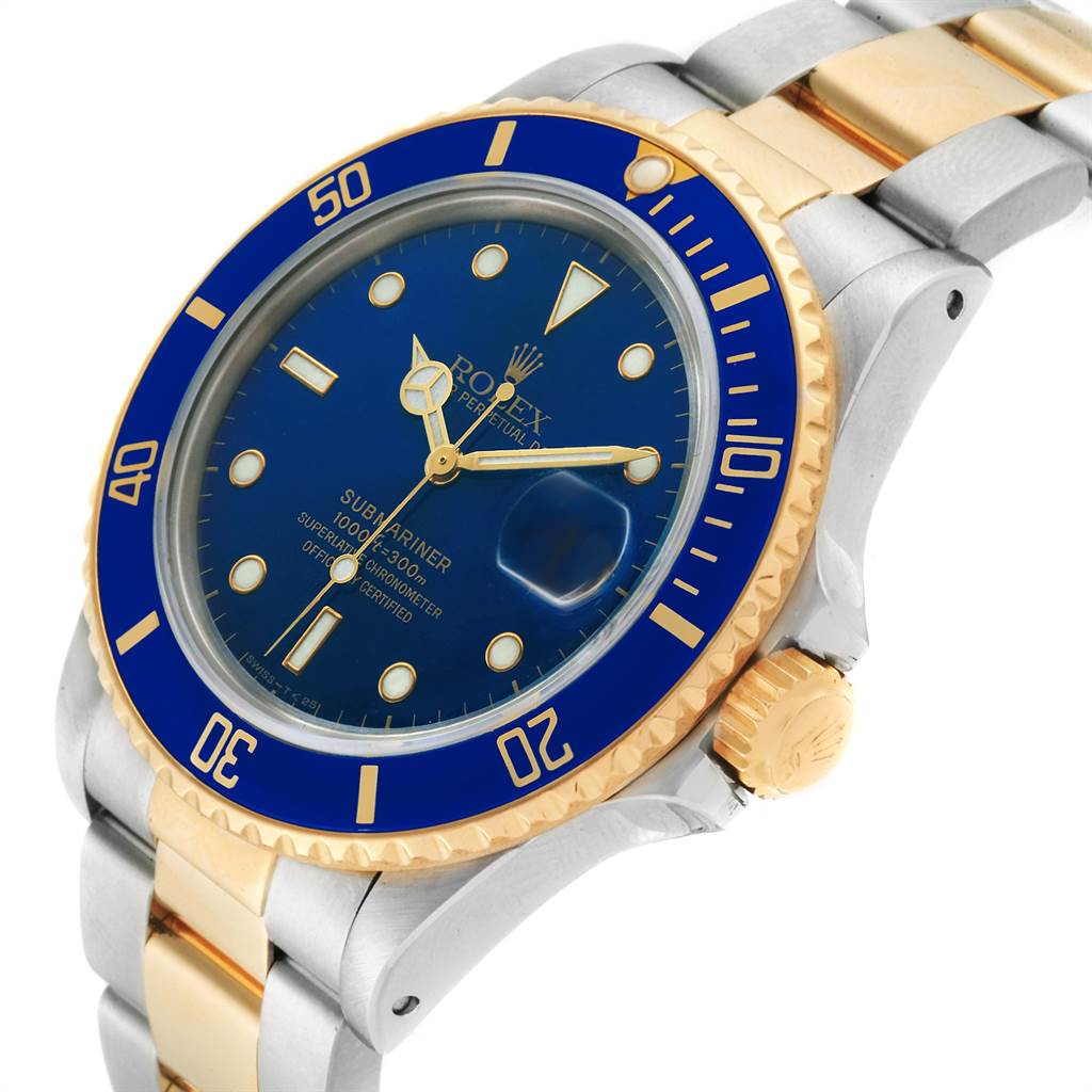 The image shows a close-up of the Rolex Submariner 16803 Men
s Steel and Gold (two tone) Blue Dial 16803 Men
s Steel and Gold (two tone) Blue Dial watch, highlighting the face, bezel, and part of the bracelet from an angled view.