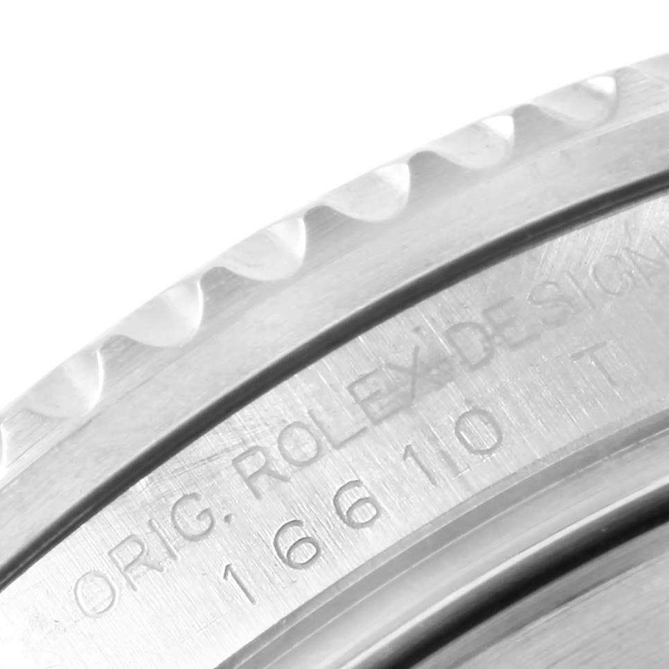 The image shows a close-up of the engraved bezel edge and serial number on a Rolex Submariner 16610 Men
s Stainless Steel Black Dial 16610 Men
s Stainless Steel Black Dial watch.