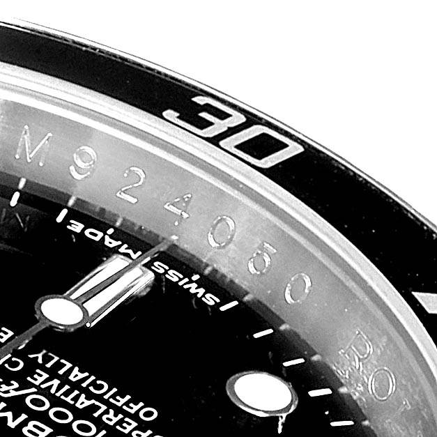 This close-up of a Rolex Submariner 16610 Men
s Stainless Steel Black Dial 16610 Men
s Stainless Steel Black Dial watch shows the bezel, part of the dial, and time markers.
