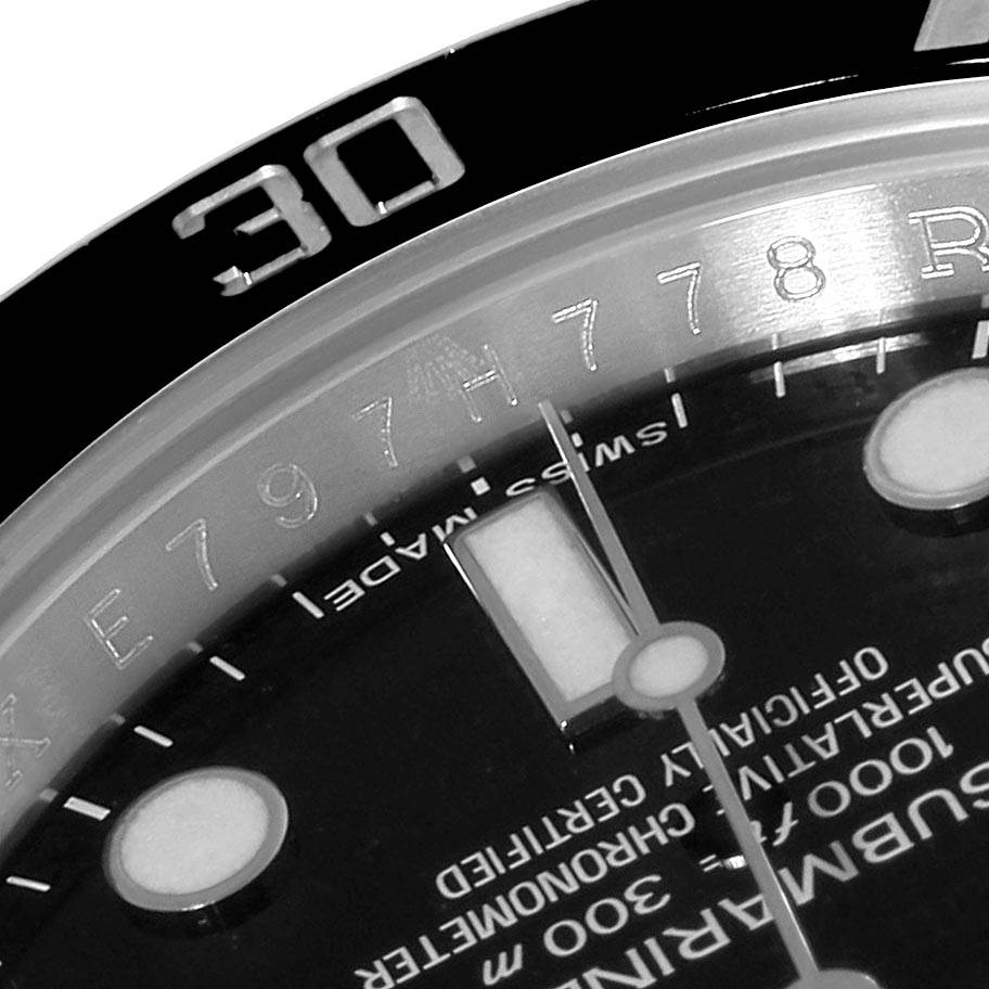 This close-up angle shows the bezel, dial, and part of the text on a Rolex Submariner 114060 Men
s Stainless Steel Black Dial 114060 Men
s Stainless Steel Black Dial watch.