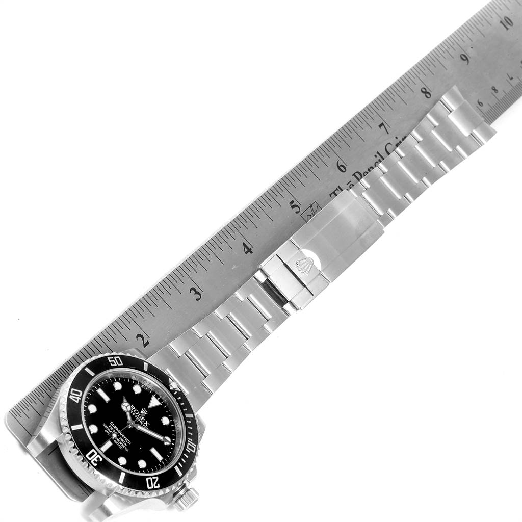 The image shows the Rolex Submariner 114060 Men
s Stainless Steel Black Dial 114060 Men
s Stainless Steel Black Dial watch face and bracelet, measured alongside a ruler at a tilted angle.