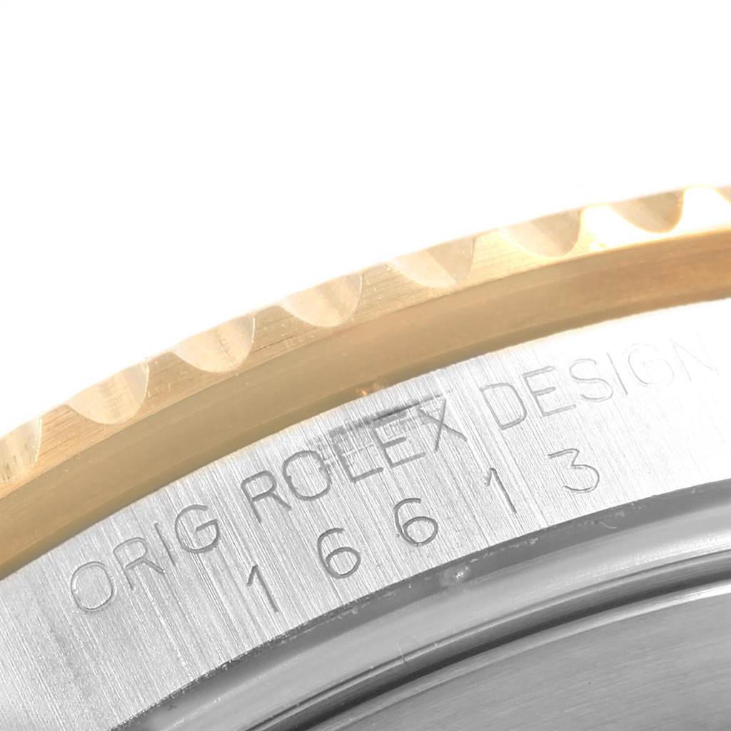 This image shows a close-up of the bezel and engraved serial number on a Rolex Submariner 16613 Men
s Steel and Gold (two tone) Black Dial 16613 Men
s Steel and Gold (two tone) Black Dial watch.