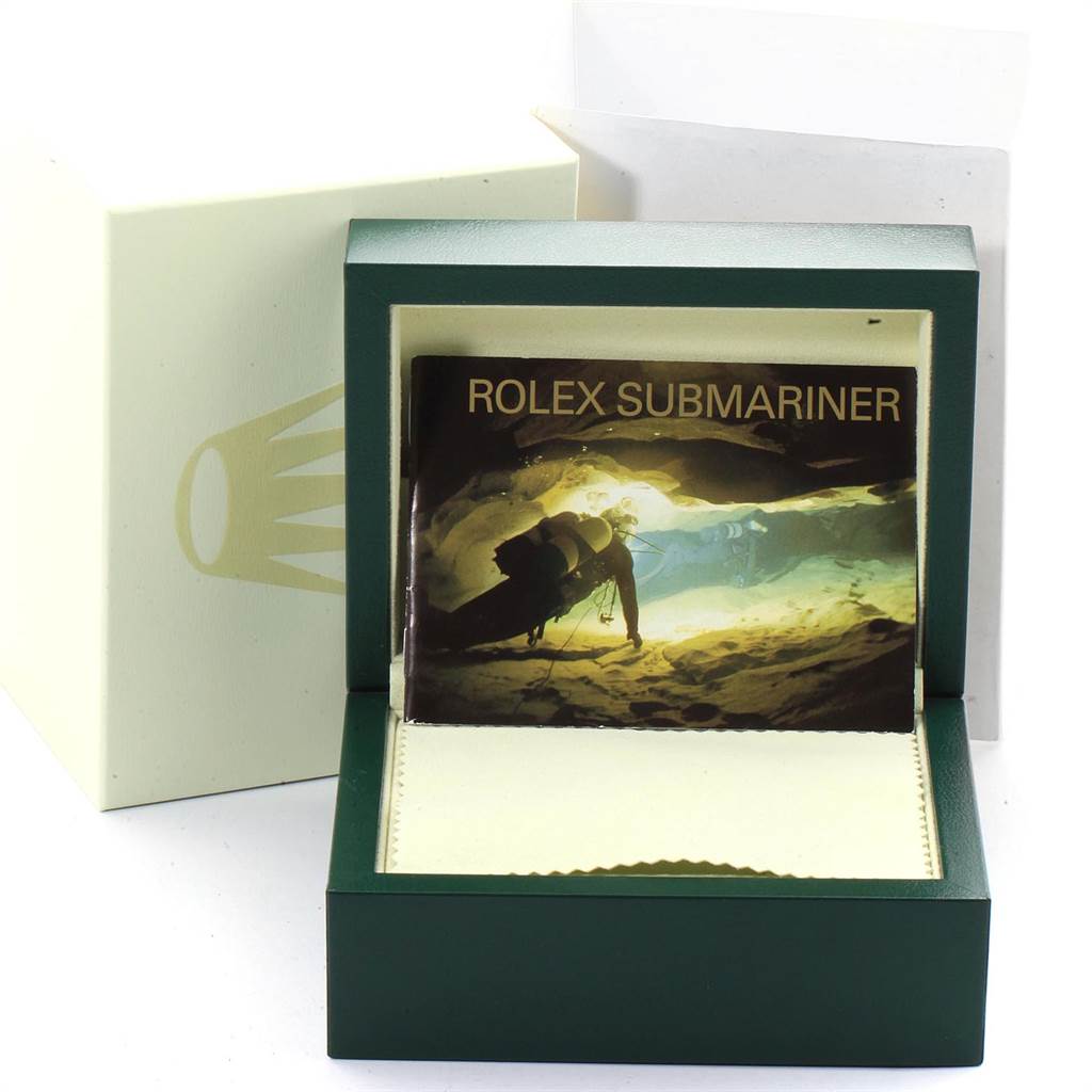 The image shows a Rolex Submariner 16610 Men
s Stainless Steel Black Dial 16610 Men
s Stainless Steel Black Dial instruction manual inside a green Rolex box with an outer white sleeve.
