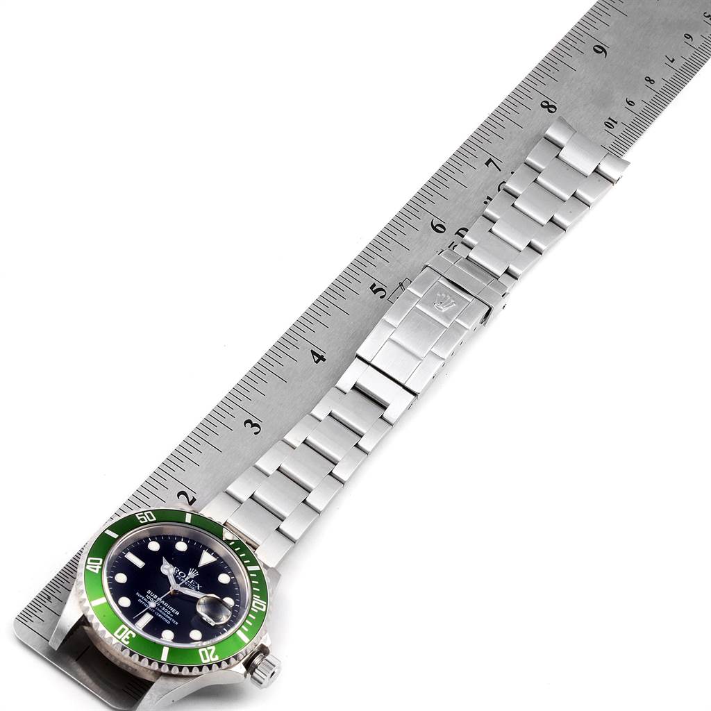 The image shows a side view of a Rolex Submariner 16610LV Men's Stainless Steel Black Dial 16610LV Men's Stainless Steel Black Dial watch, featuring its face, bezel, and bracelet, alongside a ruler for scale.