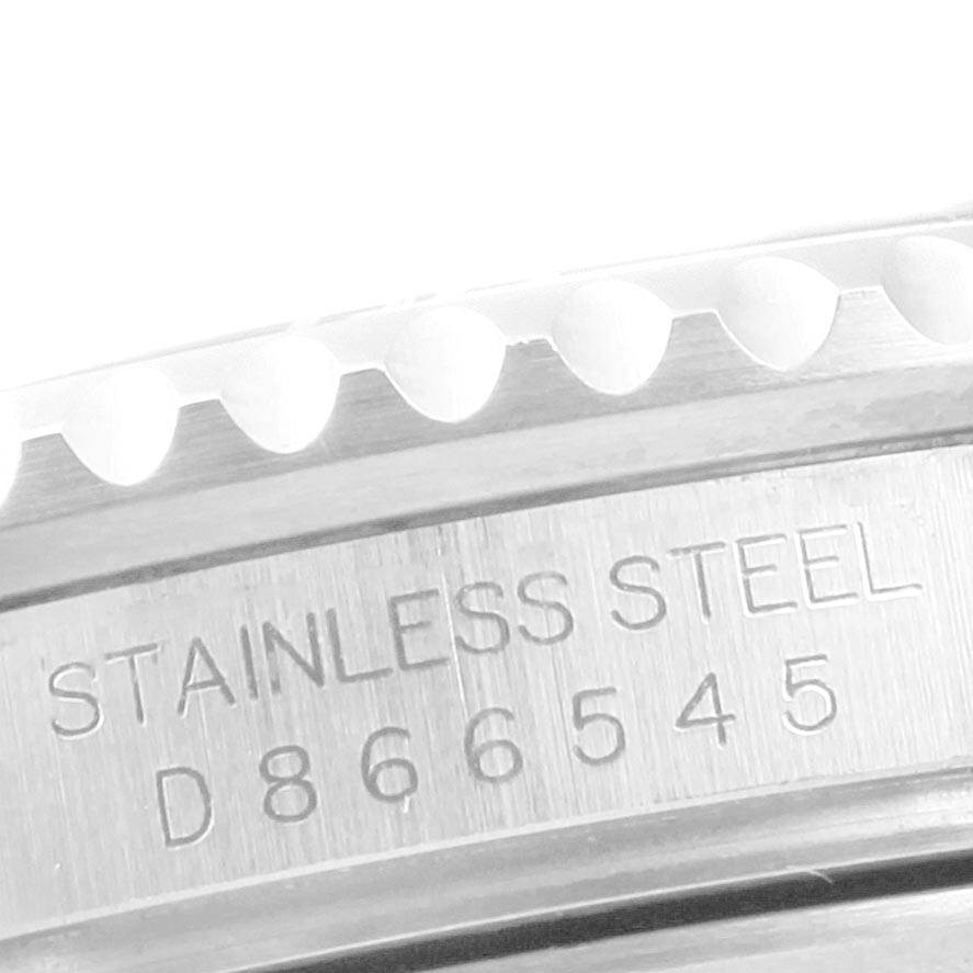 This image shows a close-up of the bezel and serial number engraving of a Rolex Submariner 16610LV Men's Stainless Steel Black Dial 16610LV Men's Stainless Steel Black Dial watch.