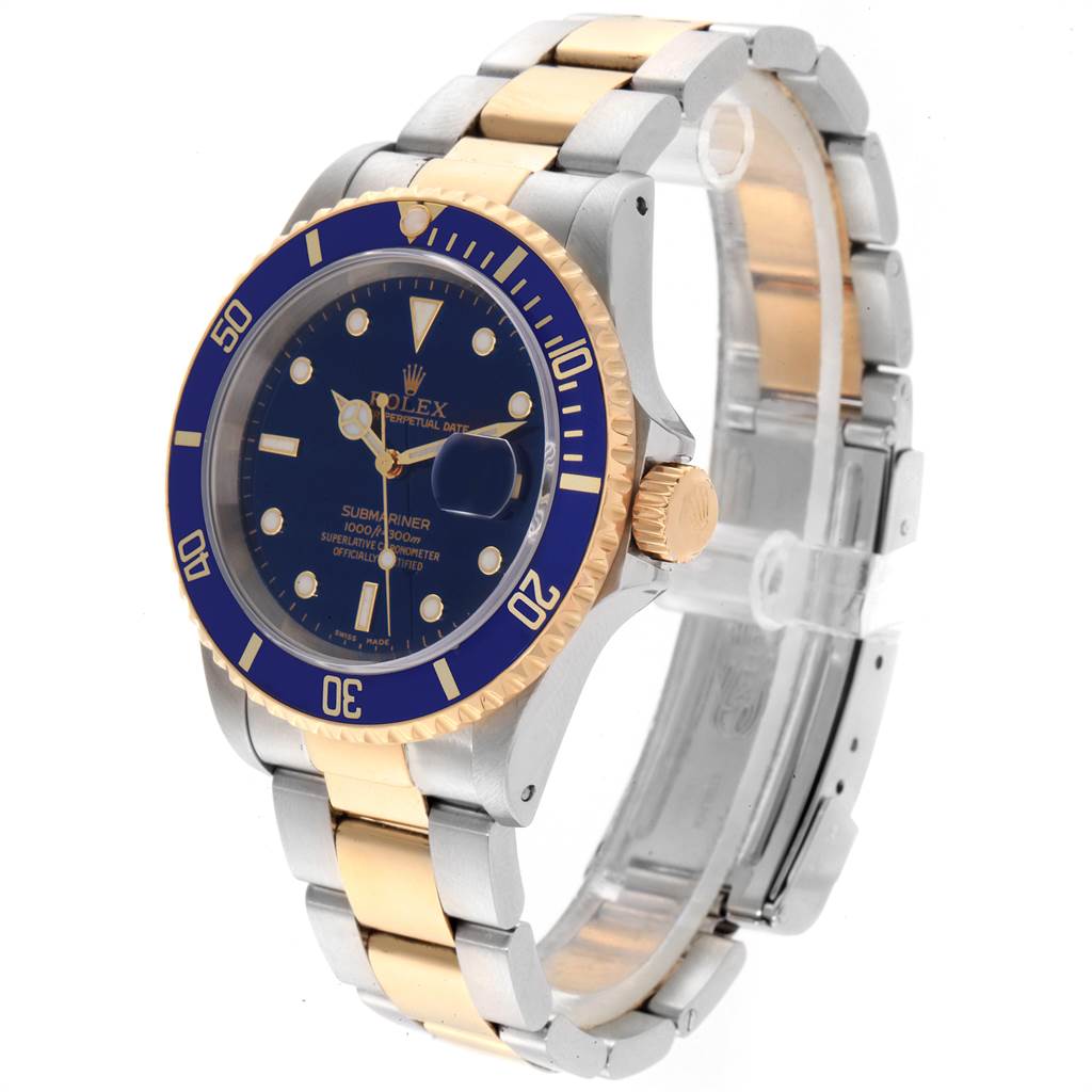 The image shows a Rolex Submariner 16613 Men
s Steel and Gold (two tone) Blue Dial 16613 Men
s Steel and Gold (two tone) Blue Dial watch at a three-quarter angle, highlighting the dial, bezel, bracelet, and clasp.