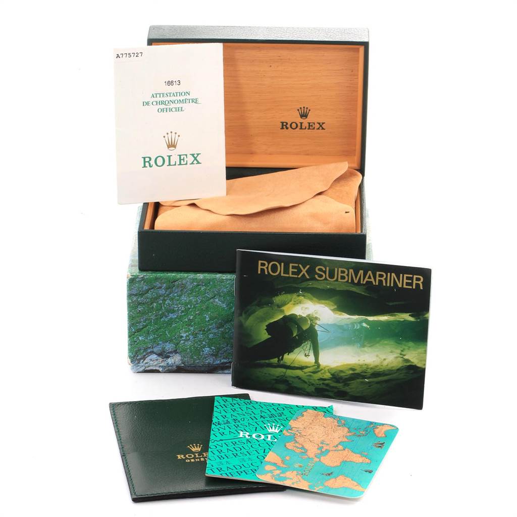 The image shows the box, manuals, and documents associated with the Rolex Submariner 16613 Men
s Steel and Gold (two tone) Blue Dial 16613 Men
s Steel and Gold (two tone) Blue Dial model.