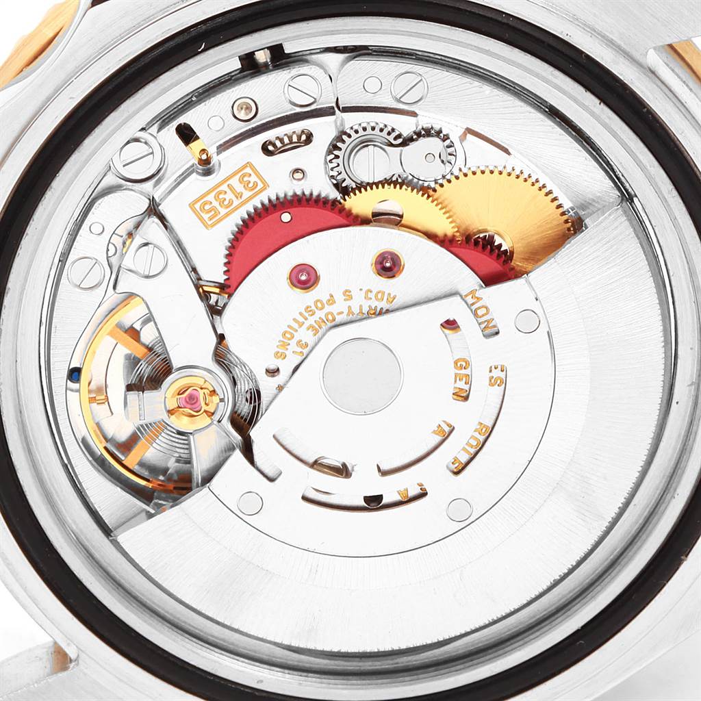 The image shows the internal mechanism of a Rolex Submariner 16613 Men
s Steel and Gold (two tone) Blue Dial 16613 Men
s Steel and Gold (two tone) Blue Dial watch with visible gears and components from a close-up angle.