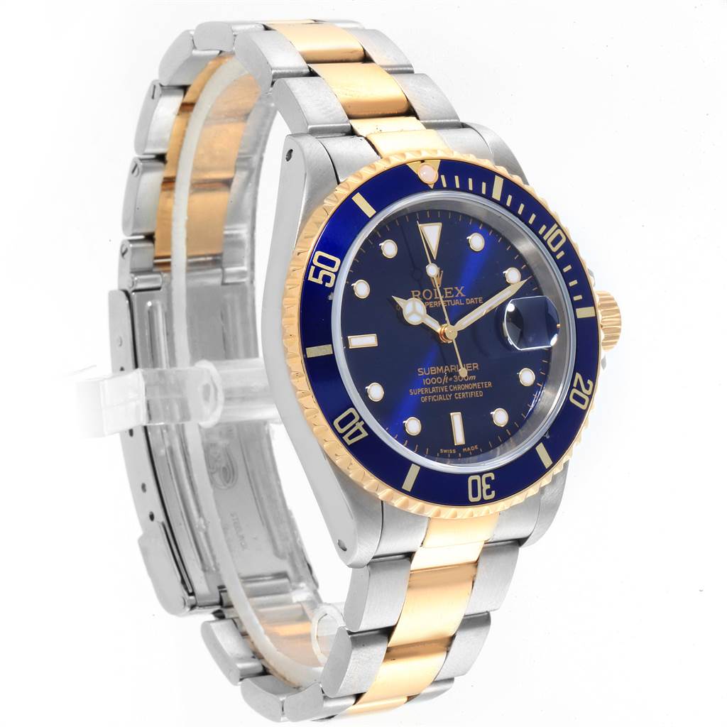 The image shows a Rolex Submariner 16613 Men
s Steel and Gold (two tone) Blue Dial 16613 Men
s Steel and Gold (two tone) Blue Dial watch at a slight angle, highlighting the dial, bezel, crown, and two-tone bracelet.