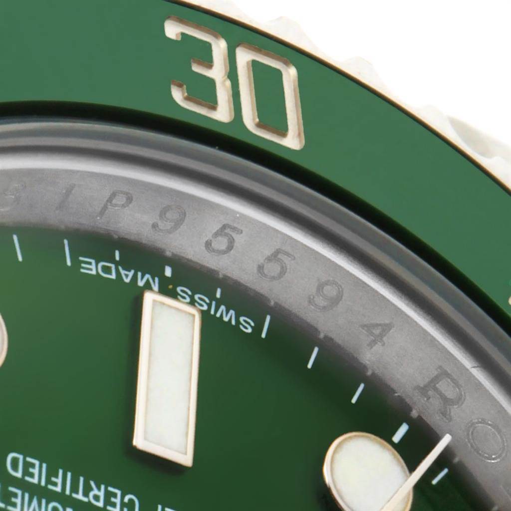 This close-up image shows part of the bezel, dial, and minute hand of a Rolex Submariner 116610LV Men
s Stainless Steel Green Dial 116610LV Men
s Stainless Steel Green Dial watch.