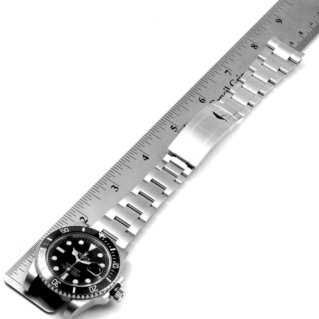 The image shows a top-down view of a Rolex Submariner 116610 Men's Stainless Steel Black Dial 116610 Men's Stainless Steel Black Dial watch with its bracelet aligned alongside a ruler.