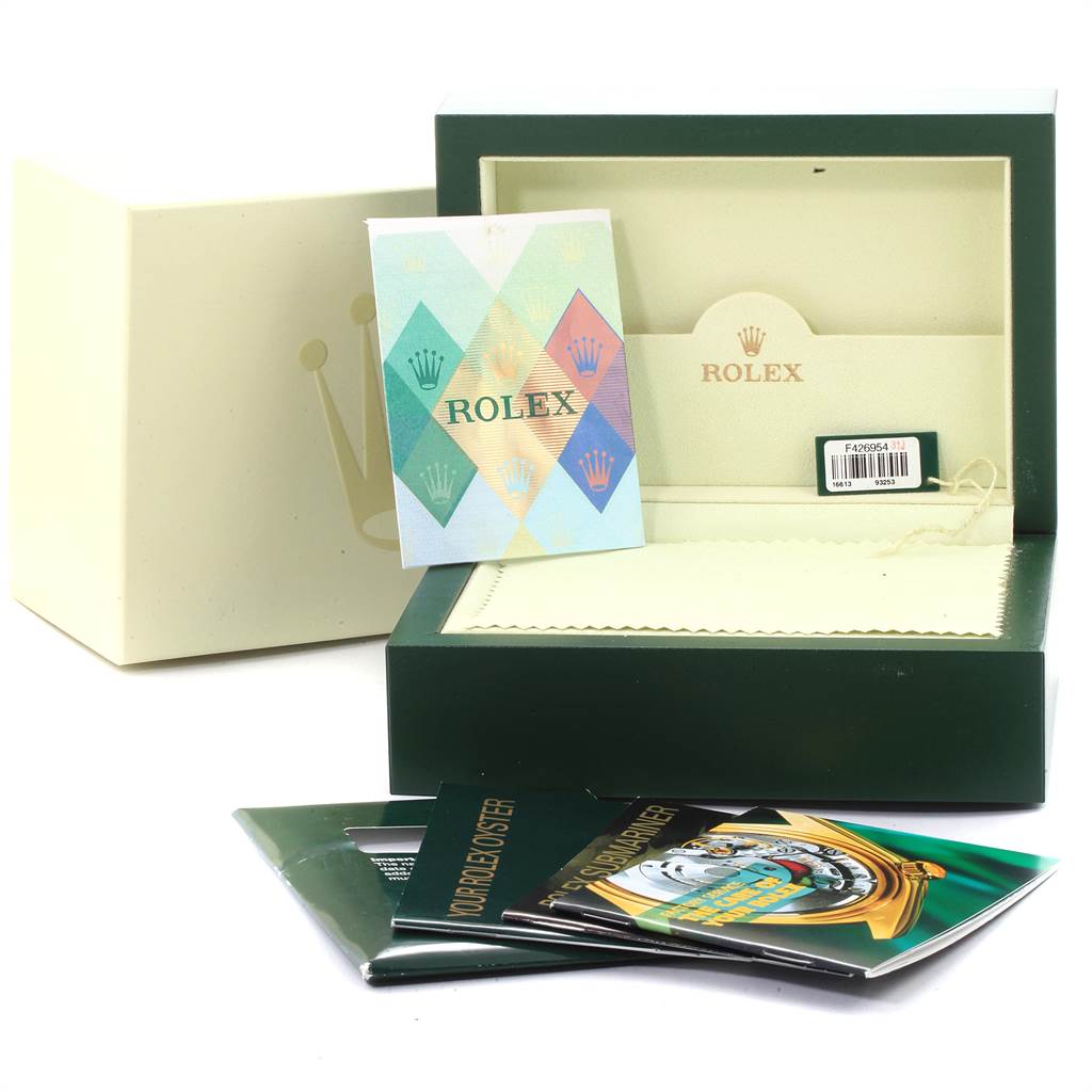 The image shows an open Rolex Submariner 16613 Men
s Steel and Gold (two tone) Grey Dial 16613 Men
s Steel and Gold (two tone) Grey Dial box with booklets and a cleaning cloth, as well as another box and cards outside.