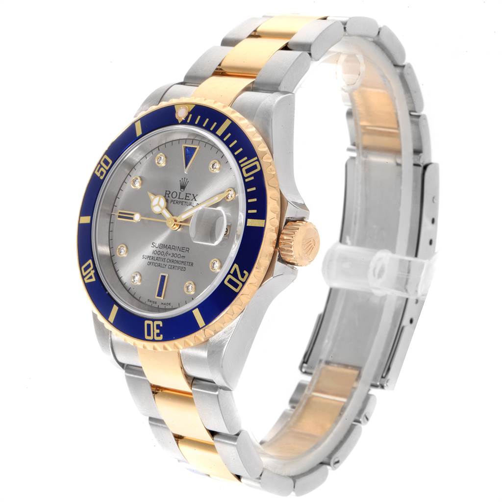 The Rolex Submariner 16613 Men
s Steel and Gold (two tone) Grey Dial 16613 Men
s Steel and Gold (two tone) Grey Dial watch is shown at a tilted angle, displaying the face, bezel, crown, and part of the bracelet.