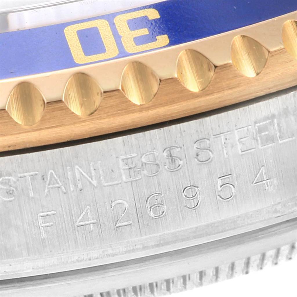 This image shows a close-up of the bezel edge and engraved model number of a Rolex Submariner 16613 Men
s Steel and Gold (two tone) Grey Dial 16613 Men
s Steel and Gold (two tone) Grey Dial watch.