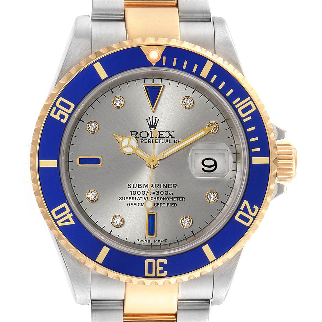 The image shows a front view of a Rolex Submariner 16613 Men
s Steel and Gold (two tone) Grey Dial 16613 Men
s Steel and Gold (two tone) Grey Dial watch featuring a blue bezel, gold and silver bracelet, and date display.