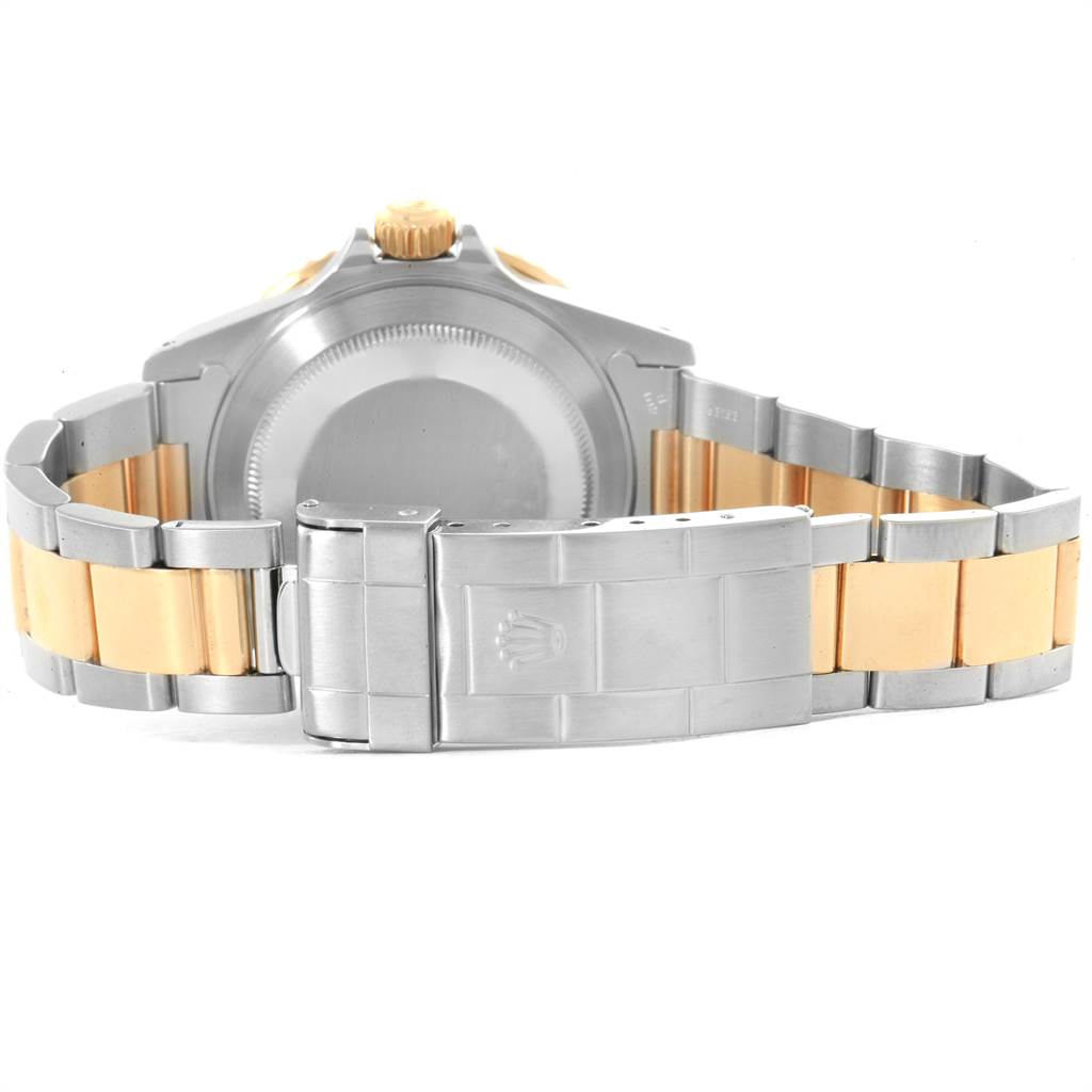 The image shows the back case and band of the Rolex Submariner 16613 Men
s Steel and Gold (two tone) Blue Dial 16613 Men
s Steel and Gold (two tone) Blue Dial watch, specifically featuring the metal clasp.