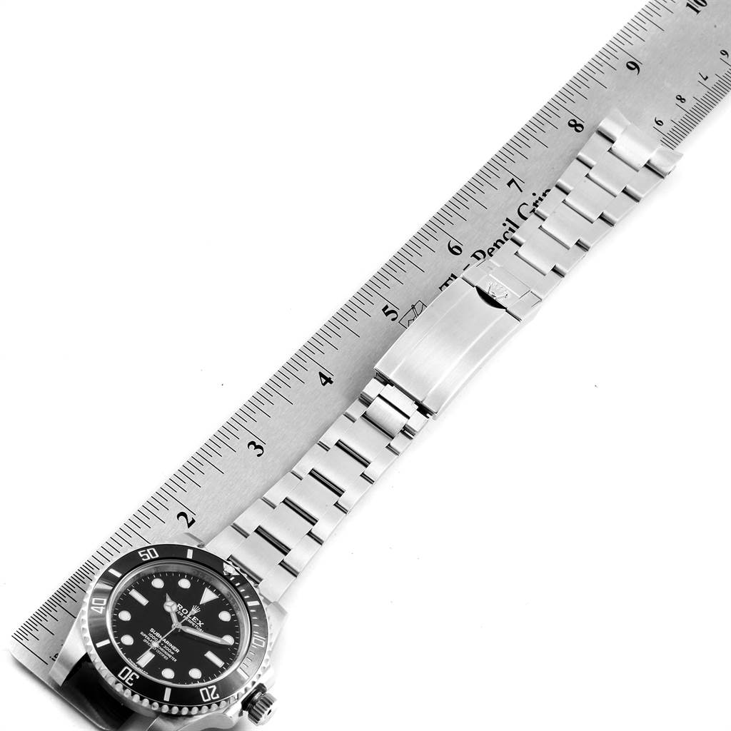 The image shows a Rolex Submariner 114060 Men
s Stainless Steel Black Dial 114060 Men
s Stainless Steel Black Dial watch laid flat with its bracelet measured against a ruler.