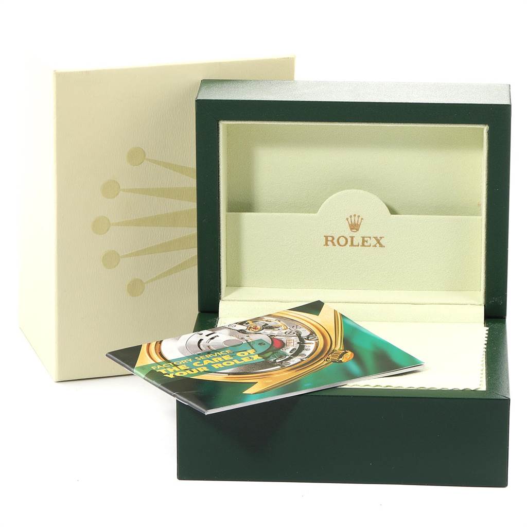 The image shows the packaging and accessories for a Rolex Submariner 16610 Men
s Stainless Steel Black Dial 16610 Men
s Stainless Steel Black Dial, including the watch box, outer box, and a booklet.
