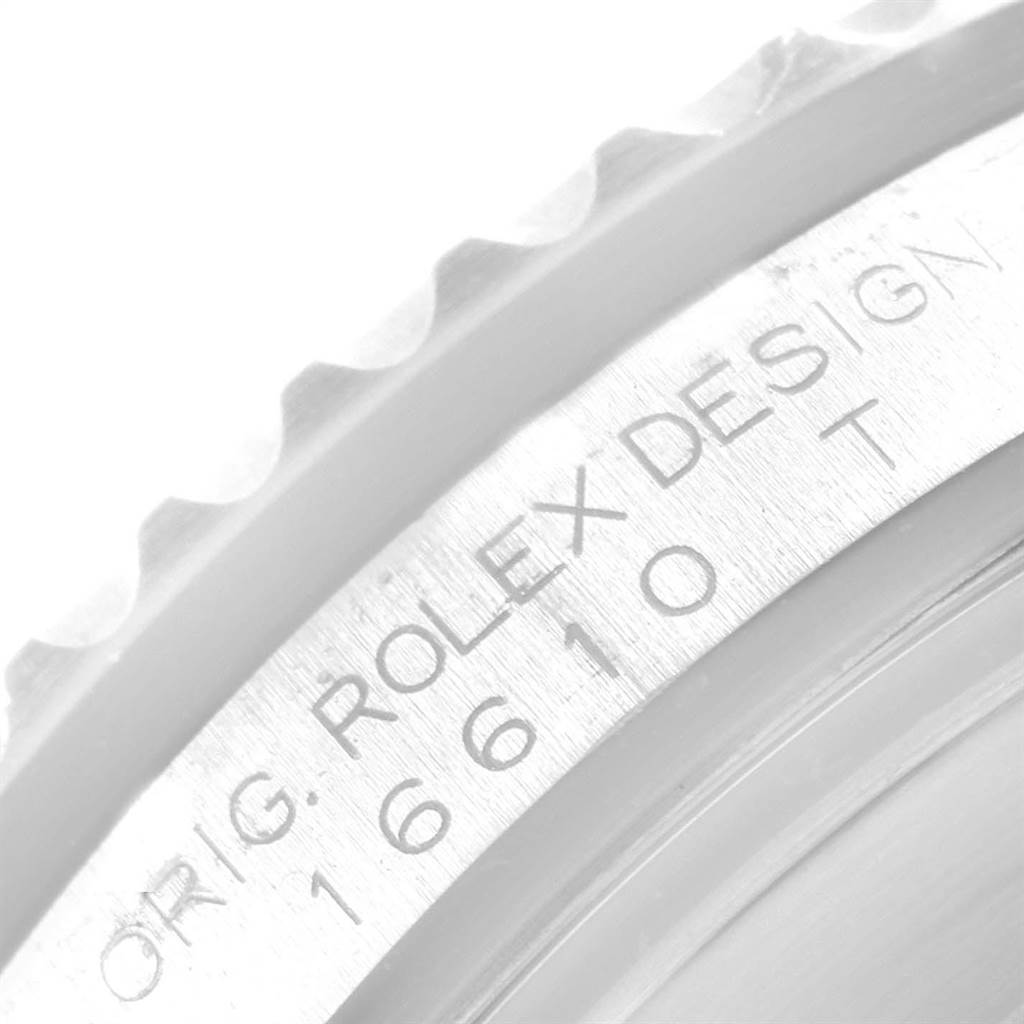 This is a close-up angle showing the engraved outer rim of the Rolex Submariner 16610 Men
s Stainless Steel Black Dial 16610 Men
s Stainless Steel Black Dial
s caseback with "ORIG. ROLEX DESIGN 16610 T".