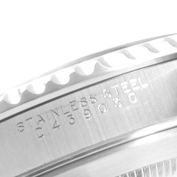 The image shows a close-up of the engraved stainless steel bezel and case of a Rolex Submariner 14060 Men
s Stainless Steel Black Dial 14060 Men
s Stainless Steel Black Dial watch.