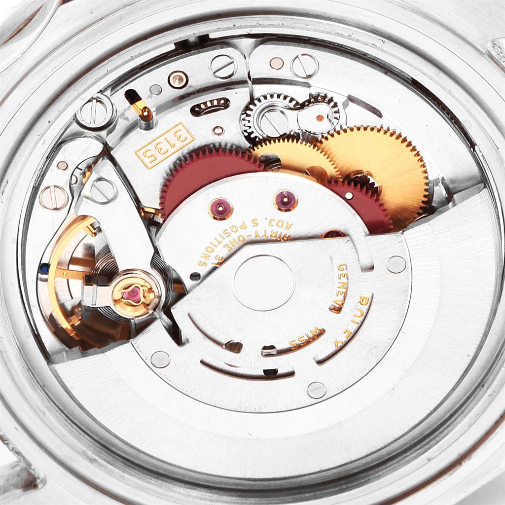 The image shows the inner mechanical movement of the Rolex Submariner 16610 Men
s Stainless Steel Black Dial 16610 Men
s Stainless Steel Black Dial watch, focusing on its intricate gears and components.