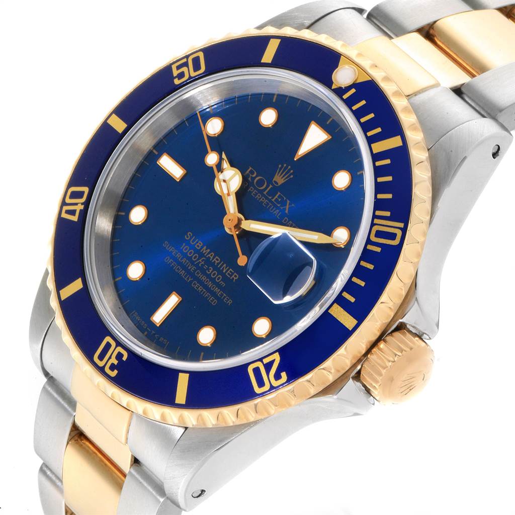 This Rolex Submariner 16613 Men
s Steel and Gold (two tone) Blue Dial 16613 Men
s Steel and Gold (two tone) Blue Dial watch is shown from a slight angle, displaying the blue dial, gold-accented bezel, and part of the bracelet.