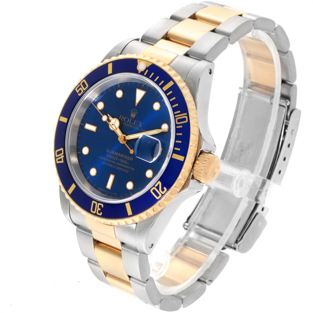 The image shows a Rolex Submariner 16613 Men
s Steel and Gold (two tone) Blue Dial 16613 Men
s Steel and Gold (two tone) Blue Dial watch from an angled perspective, highlighting its blue dial, bezel, and two-tone bracelet.
