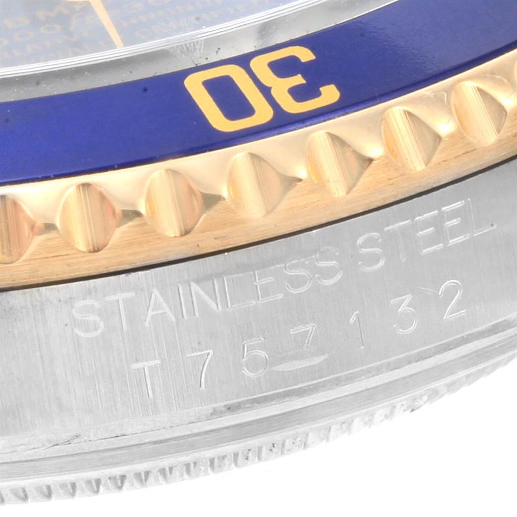 This close-up image shows the bezel and engraved side of a Rolex Submariner 16613 Men
s Steel and Gold (two tone) Blue Dial 16613 Men
s Steel and Gold (two tone) Blue Dial watch, highlighting the stainless steel and part of the model number.