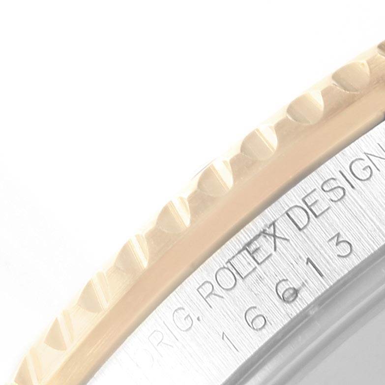 This close-up image shows the bezel and part of the engraved case side of a Rolex Submariner 16613 Men
s Steel and Gold (two tone) Blue Dial 16613 Men
s Steel and Gold (two tone) Blue Dial watch.