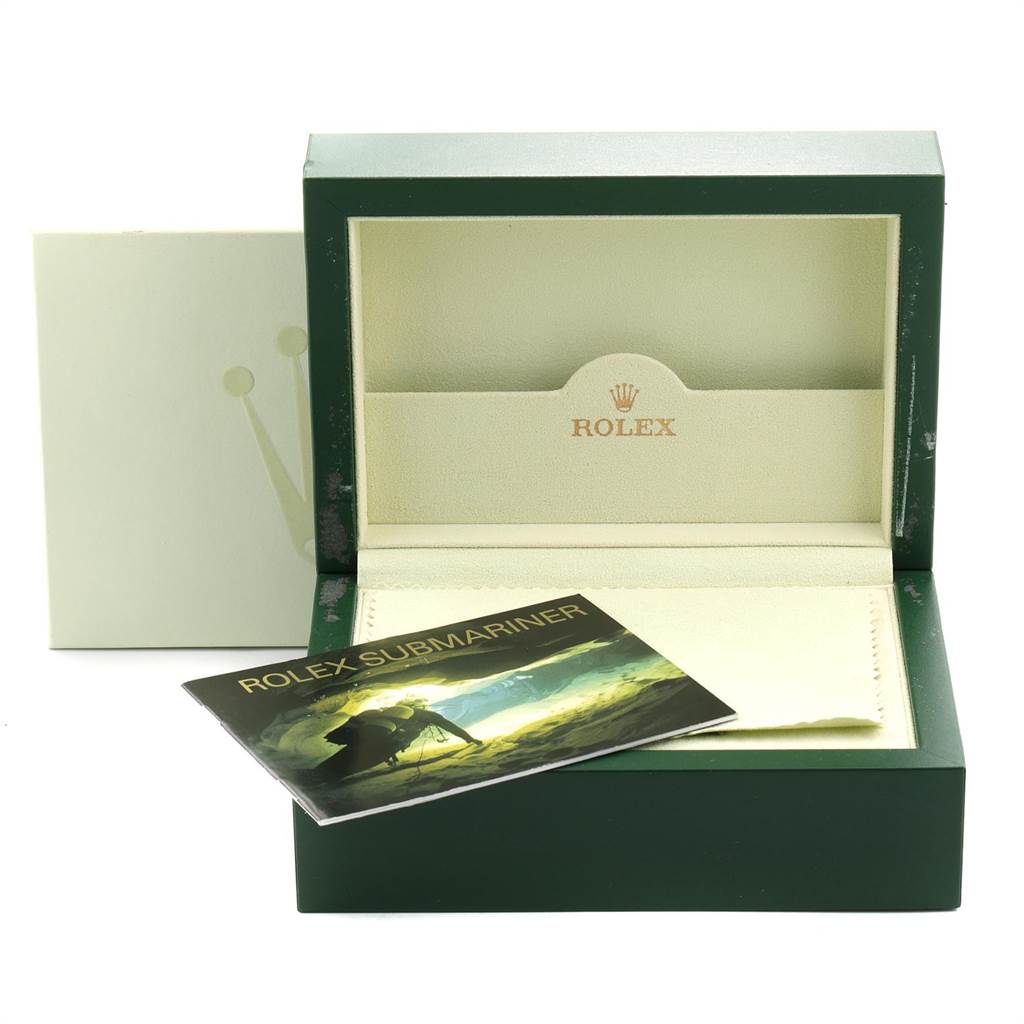 This image shows an open Rolex Submariner 16613 Men
s Steel and Gold (two tone) Blue Dial 16613 Men
s Steel and Gold (two tone) Blue Dial watch box along with its manual and outer covering.