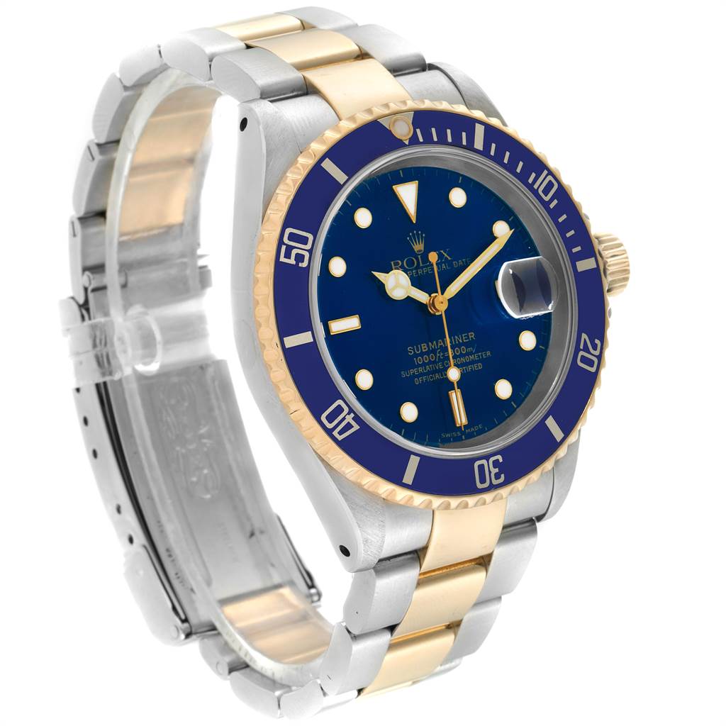 The image shows a Rolex Submariner 16613 Men
s Steel and Gold (two tone) Blue Dial 16613 Men
s Steel and Gold (two tone) Blue Dial watch at a slight angle, highlighting its blue dial, bezel, and two-tone band.