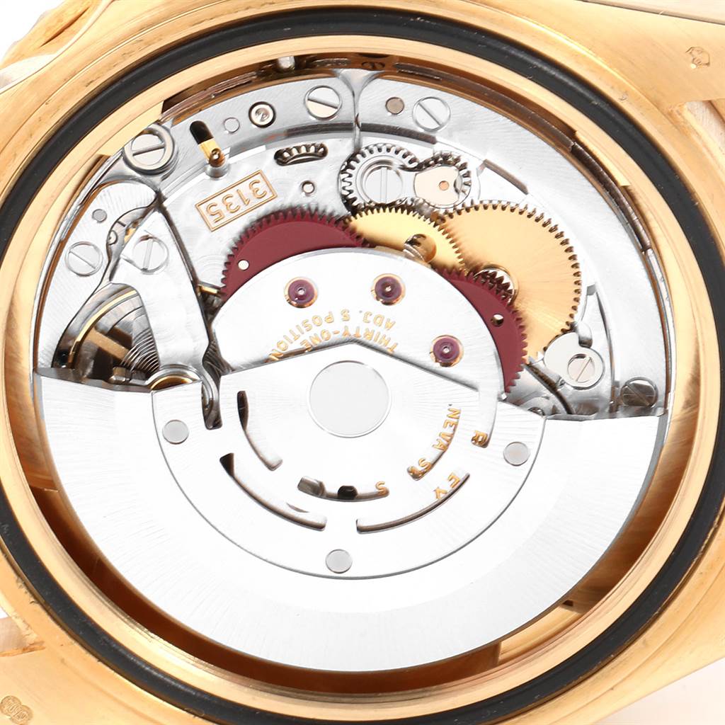 The image shows the internal mechanical movement of a Rolex Submariner 16618 Men
s Yellow Gold Black Dial 16618 Men
s Yellow Gold Black Dial watch from a rear, close-up angle.