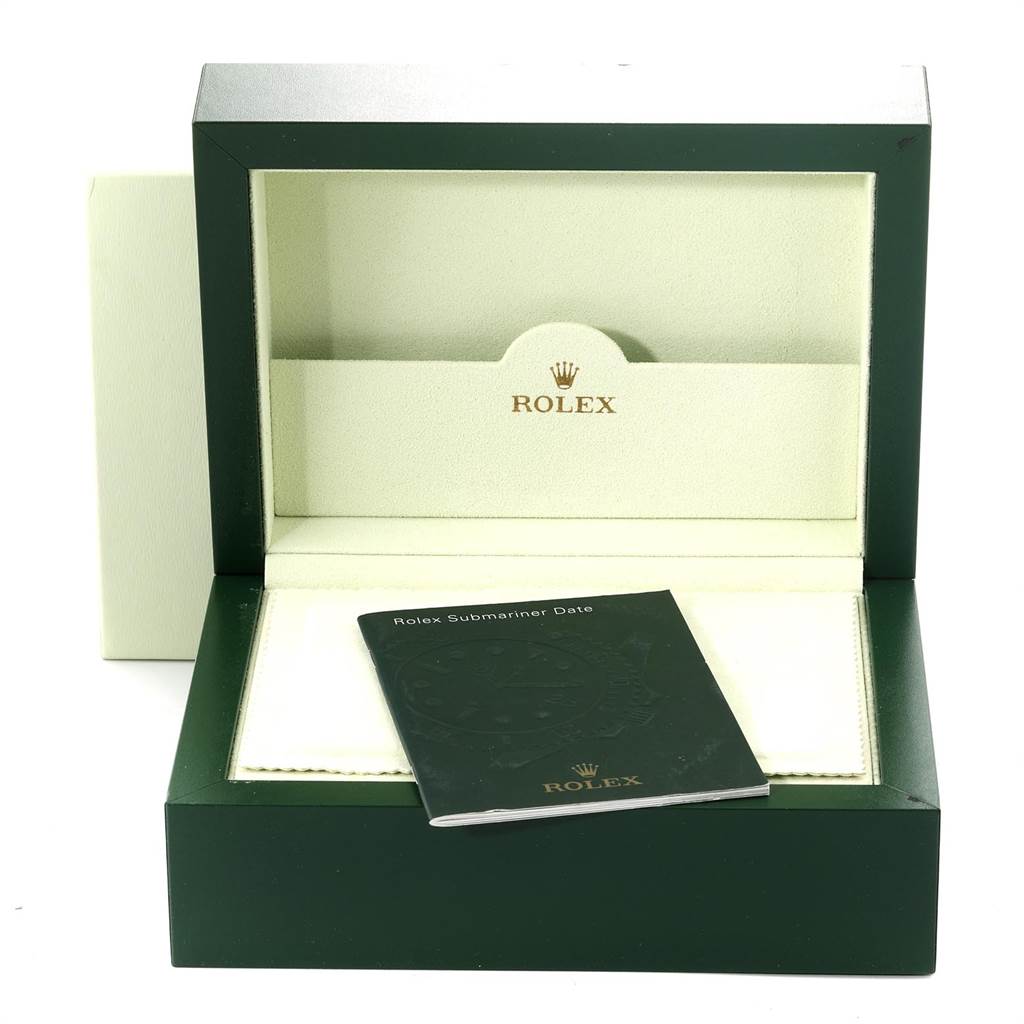 The image shows the packaging, booklet, and box of a Rolex Submariner 16618 Men
s Yellow Gold Black Dial 16618 Men
s Yellow Gold Black Dial watch.
