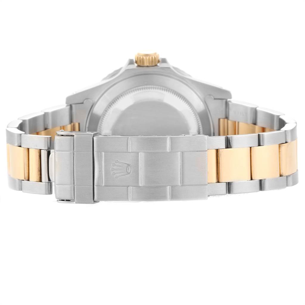 The image shows the back view of a Rolex Submariner 16613 Men
s Steel and Gold (two tone) Blue Dial 16613 Men
s Steel and Gold (two tone) Blue Dial, highlighting its two-tone bracelet and clasp.