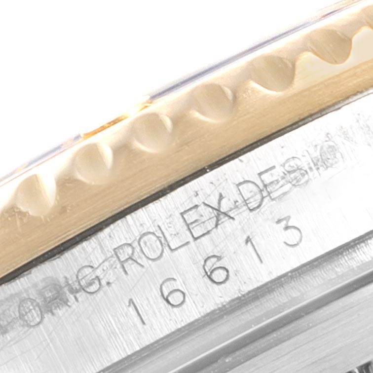 This close-up image shows the bezel and engraved serial numbers on the case side of a Rolex Submariner 16613 Men
s Steel and Gold (two tone) Blue Dial 16613 Men
s Steel and Gold (two tone) Blue Dial model 16613 watch.