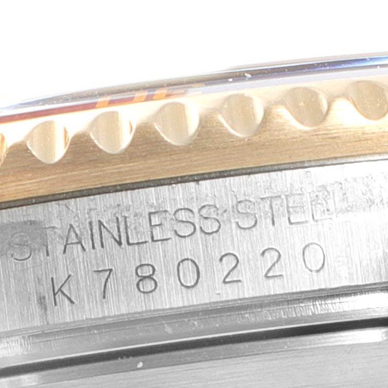 The image shows a close-up view of the case side and bezel of a Rolex Submariner 16613 Men
s Steel and Gold (two tone) Blue Dial 16613 Men
s Steel and Gold (two tone) Blue Dial watch, displaying its serial number.