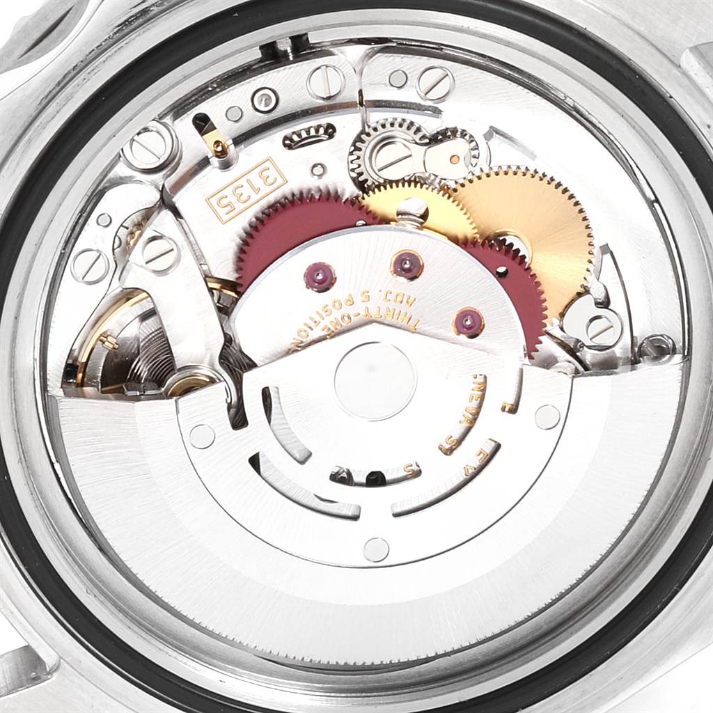 The image shows an internal view of the Rolex Submariner 16610 Men
s Stainless Steel Black Dial 16610 Men
s Stainless Steel Black Dial movement, revealing gears and mechanical components.