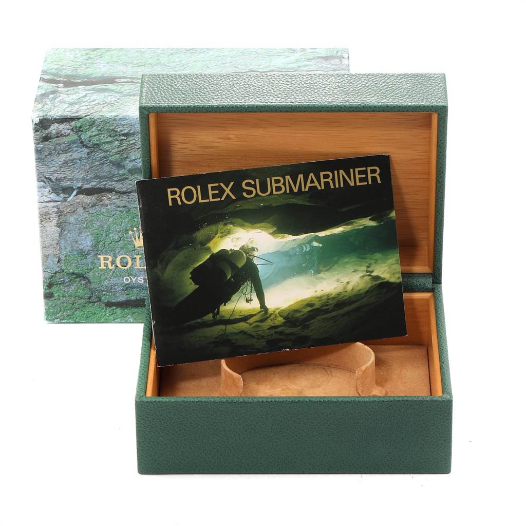 The image shows a Rolex Submariner 16613 Men
s Steel and Gold (two tone) Blue Dial 16613 Men
s Steel and Gold (two tone) Blue Dial box and booklet at an angle showing the interior and exterior of the box.