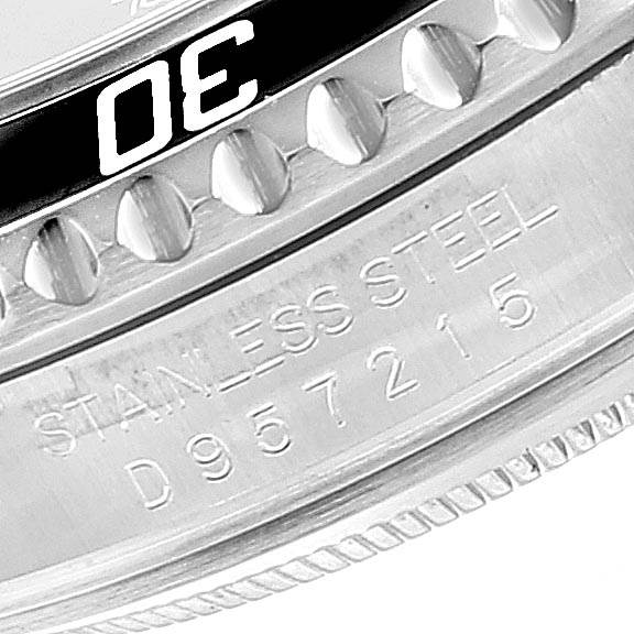 The image shows a close-up of the stainless steel case and bezel of a Rolex Submariner 16610 Men
s Stainless Steel Black Dial 16610 Men
s Stainless Steel Black Dial watch, including its serial number.