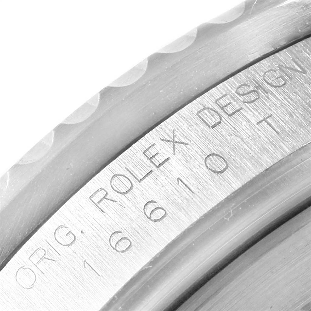 The image shows a close-up of the case engraving on a Rolex Submariner 16610 Men
s Stainless Steel Black Dial 16610 Men
s Stainless Steel Black Dial watch, showing model number and brand details.