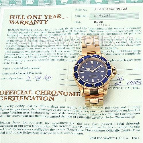 The image shows a Rolex Submariner 16618 Men's Stainless Steel Blue Dial 16618 Men's Stainless Steel Blue Dial watch placed on its warranty and official chronometer certification document.