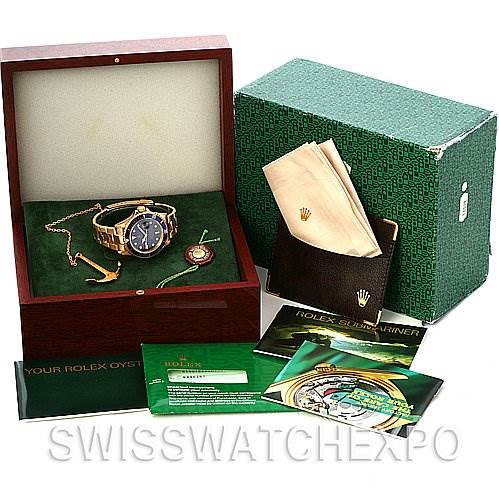 The Rolex Submariner 16618 Men's Stainless Steel Blue Dial 16618 Men's Stainless Steel Blue Dial watch is displayed inside an open box, alongside manuals, a polishing cloth, and original packaging.