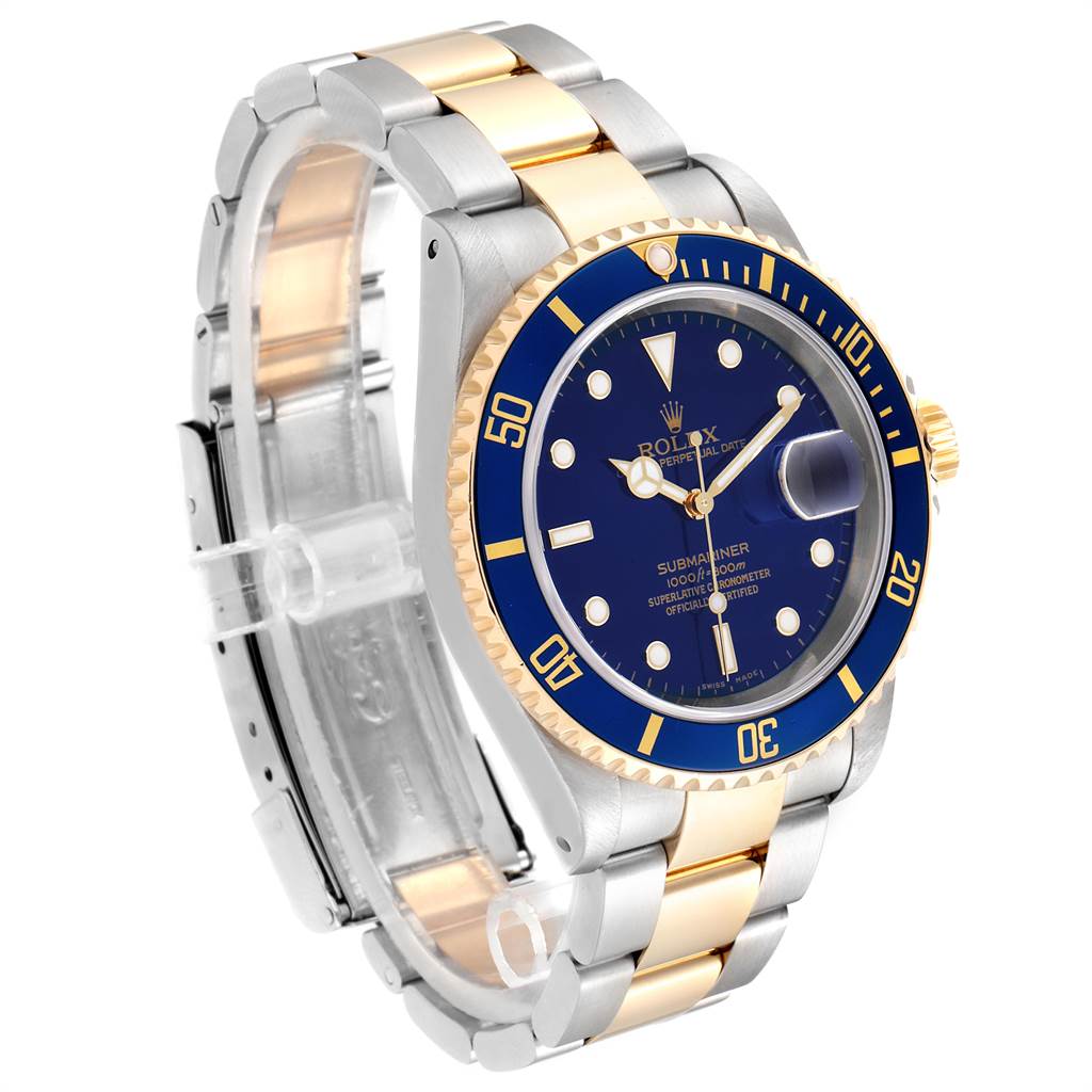The image shows a Rolex Submariner 16613 Men's Steel and Gold (two tone) Blue Dial 16613 Men's Steel and Gold (two tone) Blue Dial watch from a front-side angle, highlighting its blue dial, gold bezel, and two-tone bracelet.