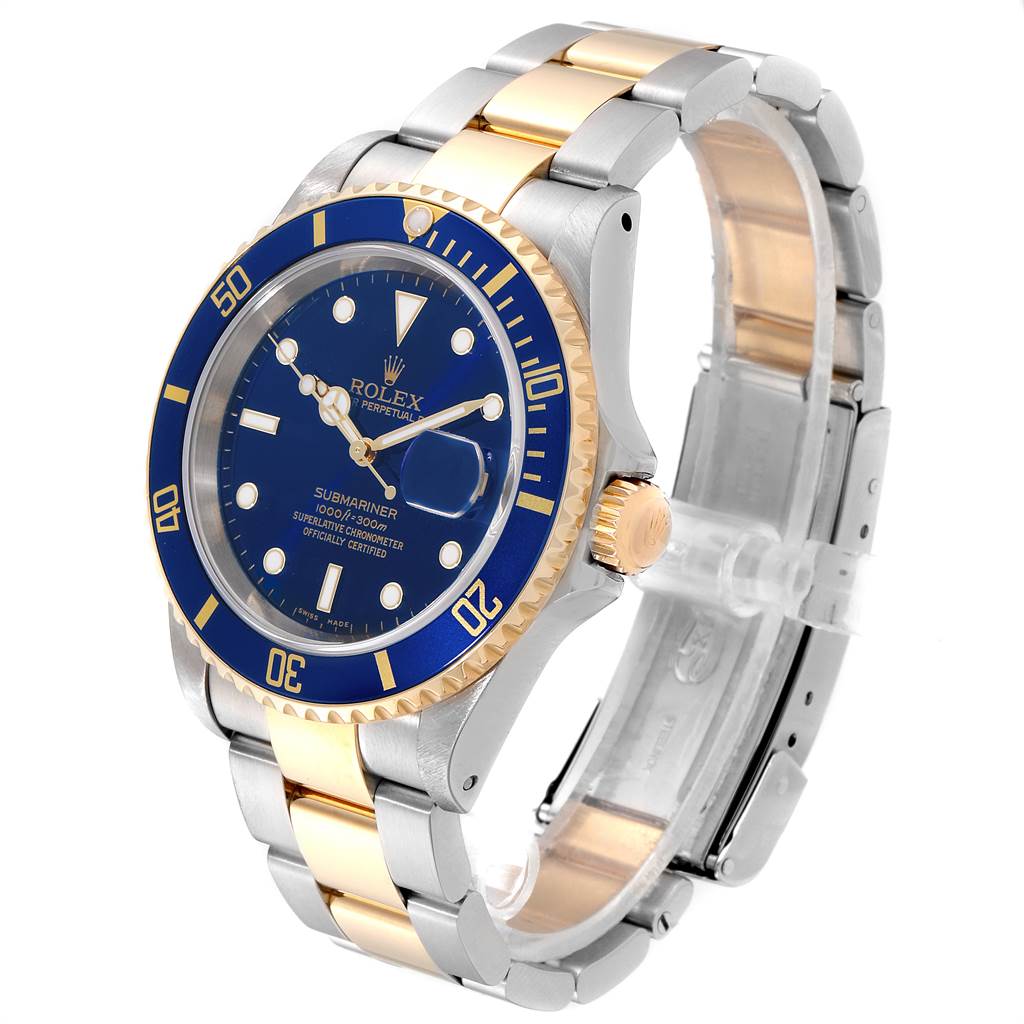 The image shows a Rolex Submariner 16613 Men's Steel and Gold (two tone) Blue Dial 16613 Men's Steel and Gold (two tone) Blue Dial watch at a three-quarter angle, highlighting its blue dial, bezel, and two-tone bracelet.